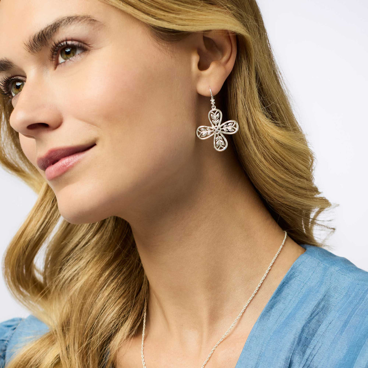 Polished silver Justine earring with a refined wire hook design.