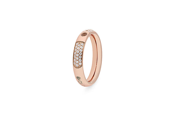 Rose gold ring with pave diamonds on a curved band, featuring a small circular detail.