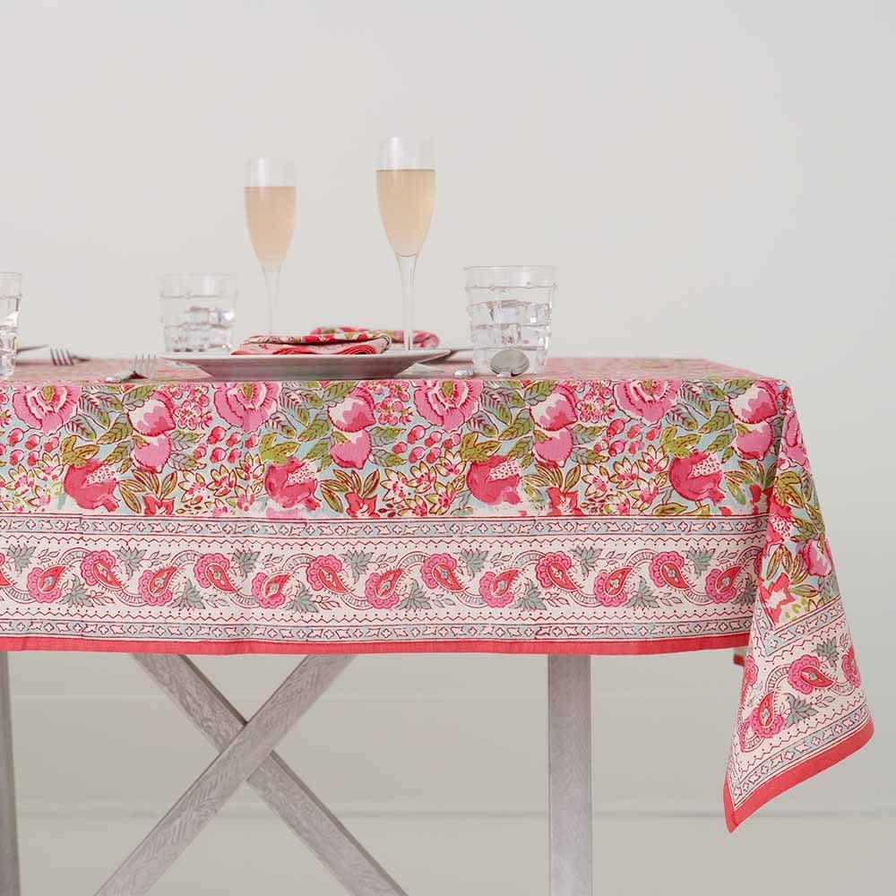 Cotton tablecloth with a wildflower garden pattern featuring pinks and lime green.