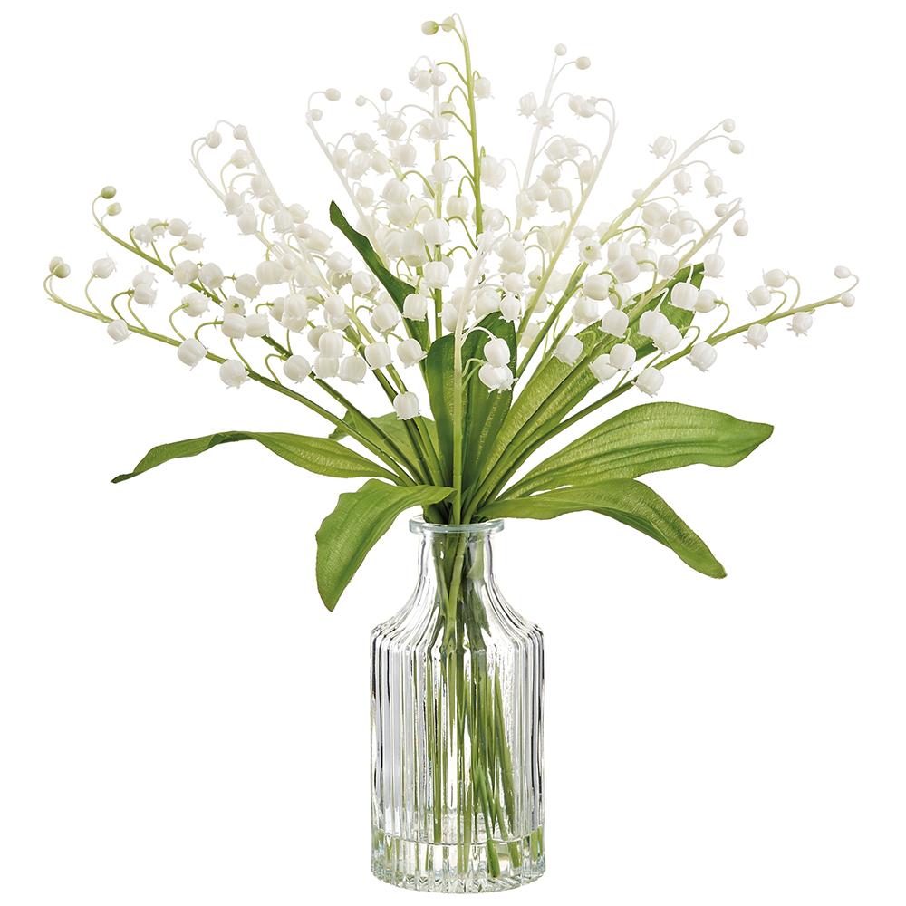 White glass vase holding a bouquet of white lily of the valley flowers.