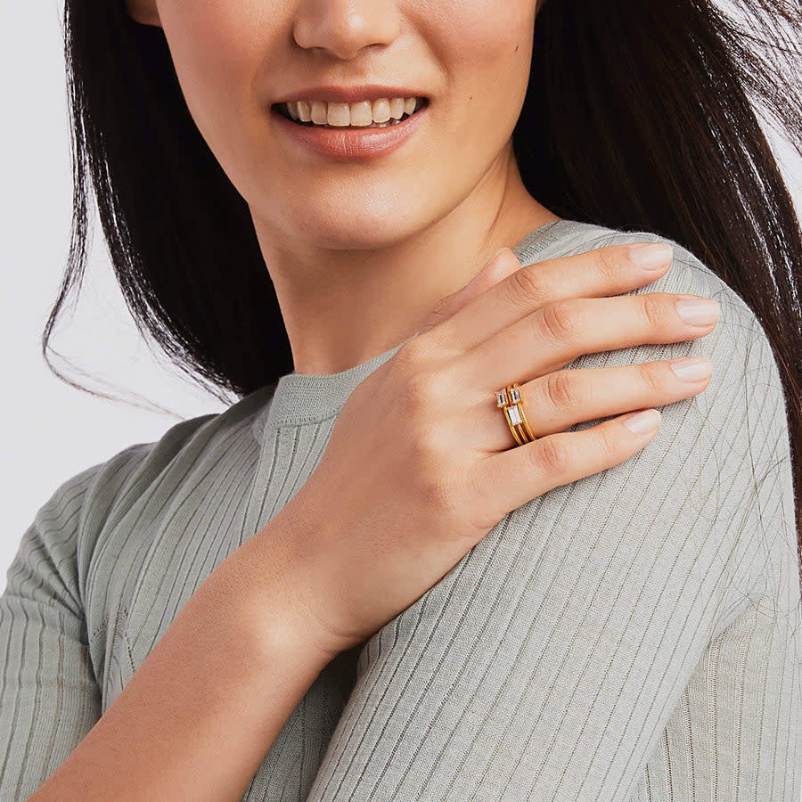 Three stacked gold bands with rectangular cubic zirconia stones