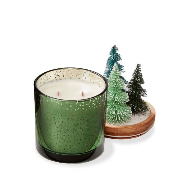 Bronze bottle brush lid on a glass candle with wood wick