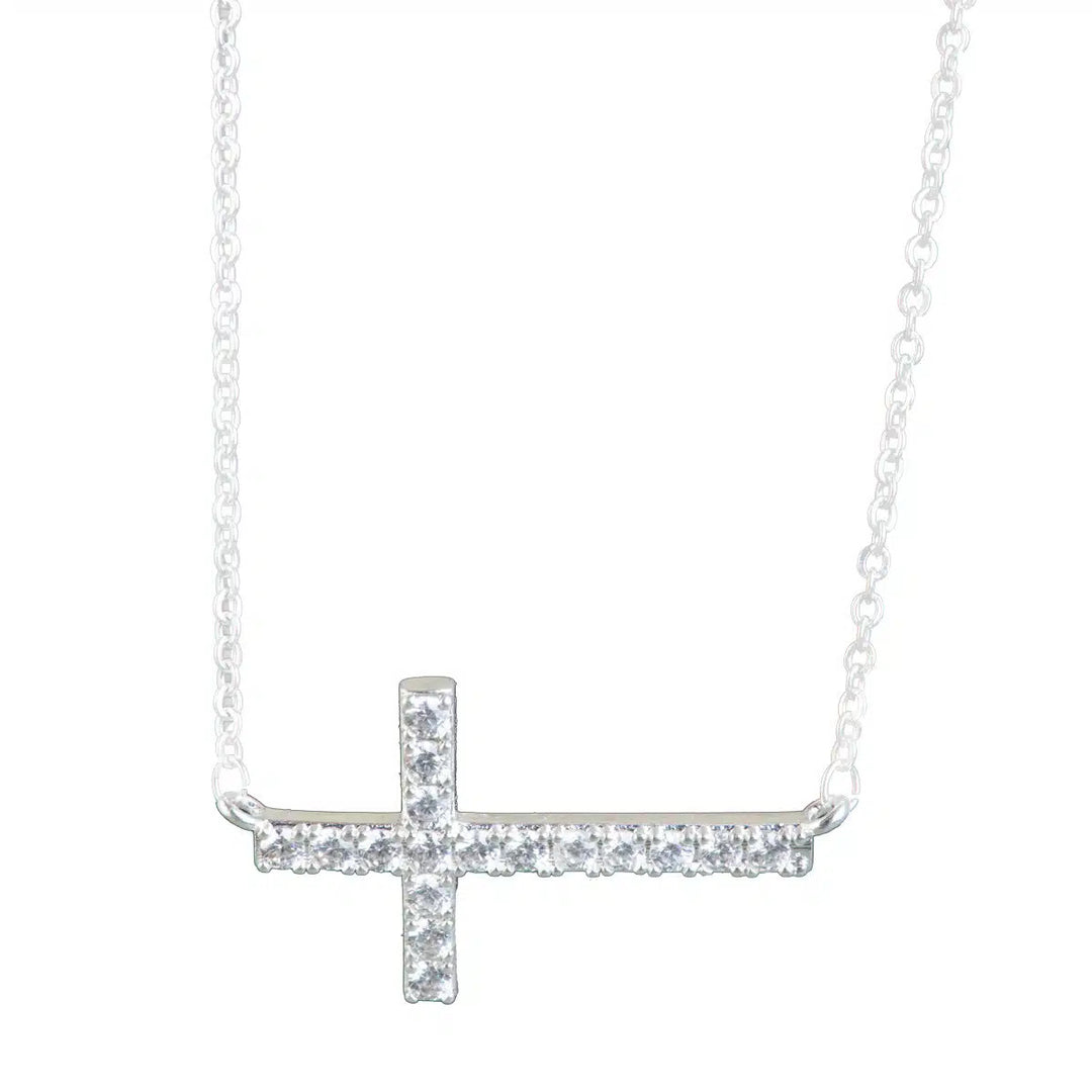 Silver laying cross necklace with clear cubic zirconia stones on a delicate chain.