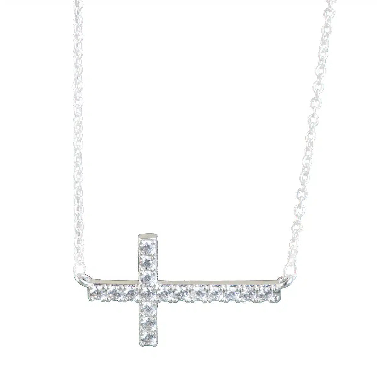 Silver laying cross necklace with clear cubic zirconia stones on a delicate chain.