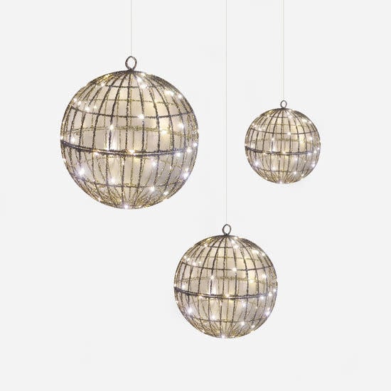 Wire frame nested ball decoration in silver with a spherical silhouette.