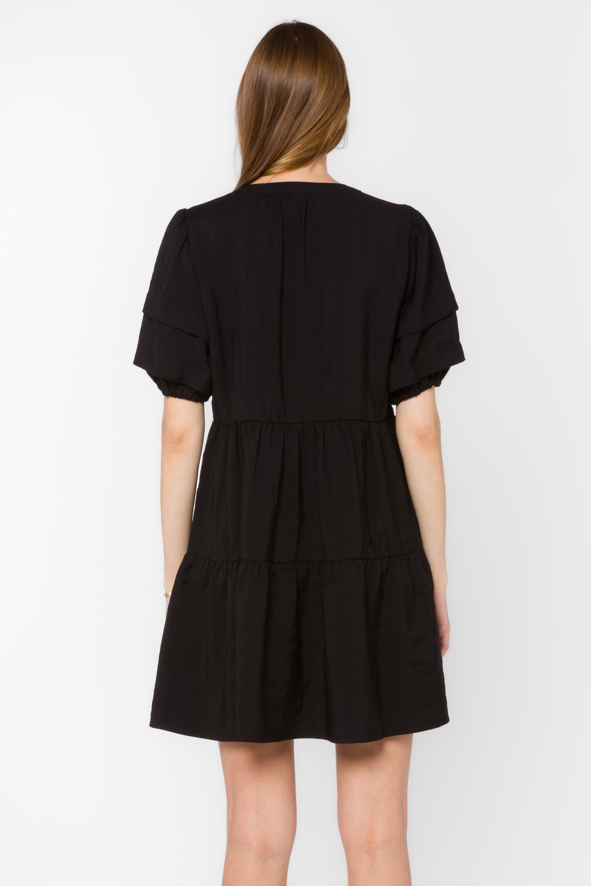 Melita dress in black viscose blend with mandarin collar, pleated puff sleeves, and tiered mini silhouette.