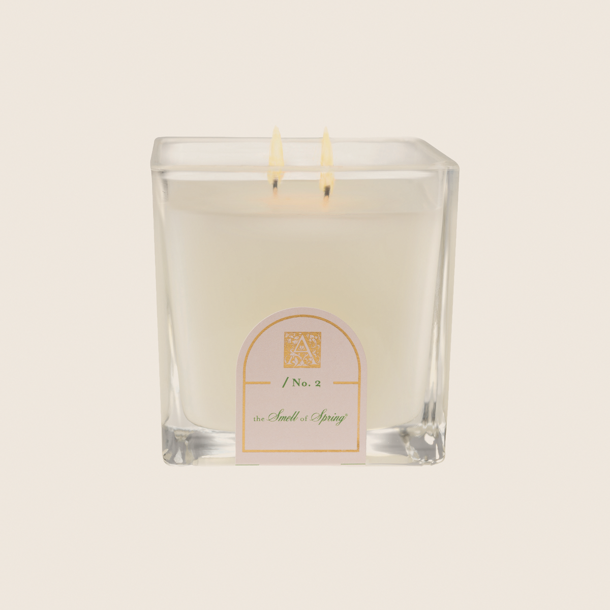 Cube glass candle with white wax featuring pineapple, hyacinth, jasmine, rose, balsamic, and vanilla scents.