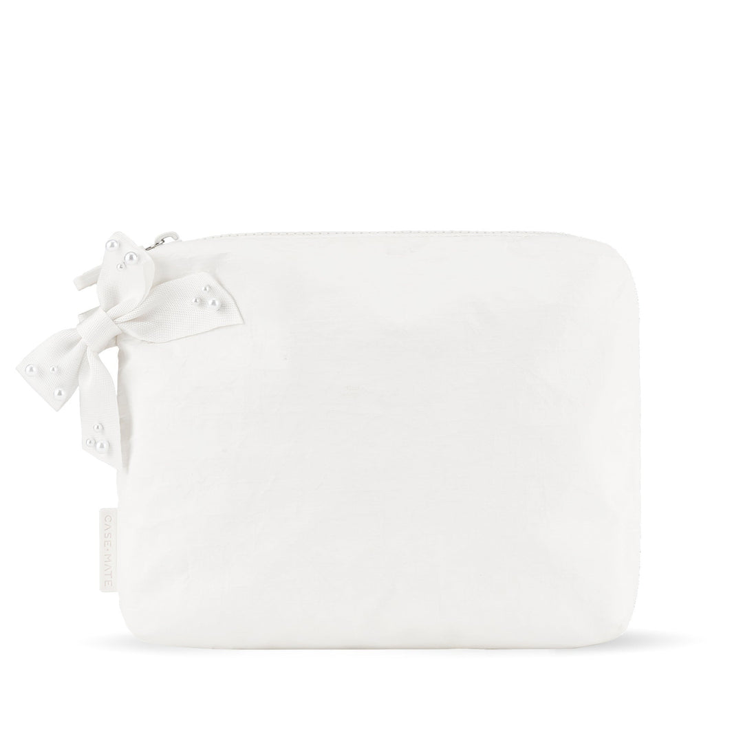 White crinkle makeup bag with a large bow detail and pearl accents.