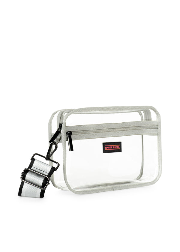 Drew Clear Crossbody bag with a vinyl body, grey trim, and a striped adjustable shoulder strap.