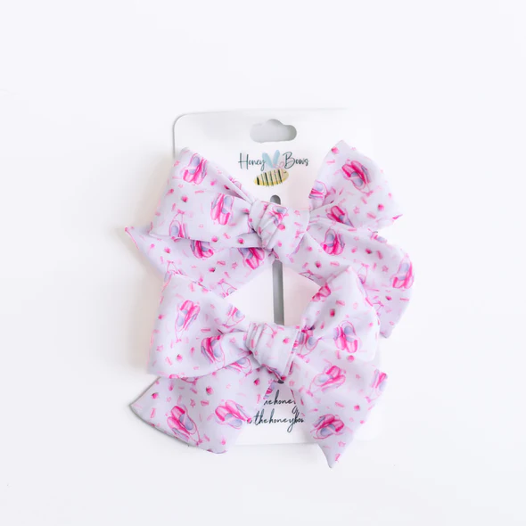 Two 3.5-inch white hair bows with a pink ballet slipper pattern on a display card.