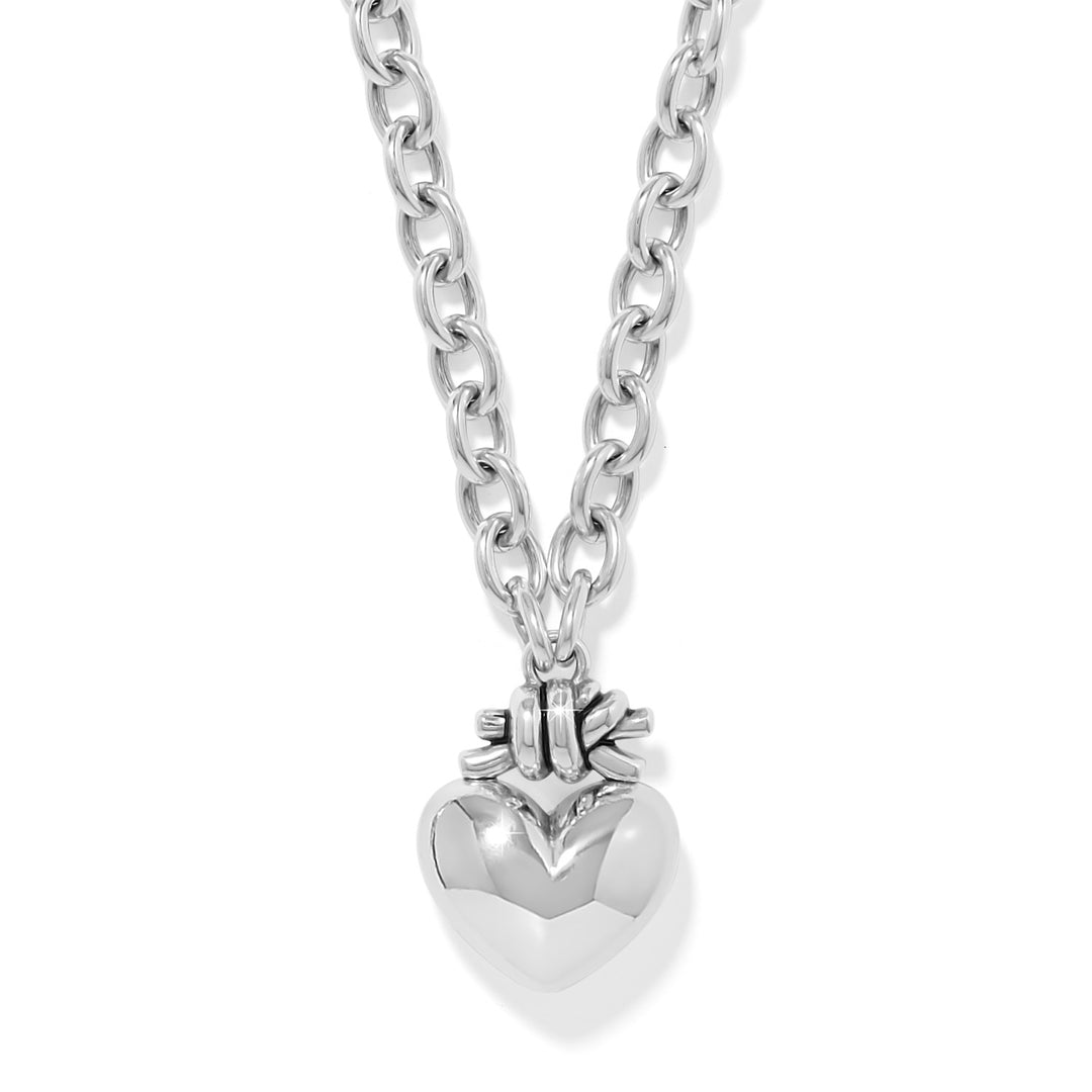 Silver plated heart pendant necklace with a love knot chain on an adjustable lobster claw clasp.