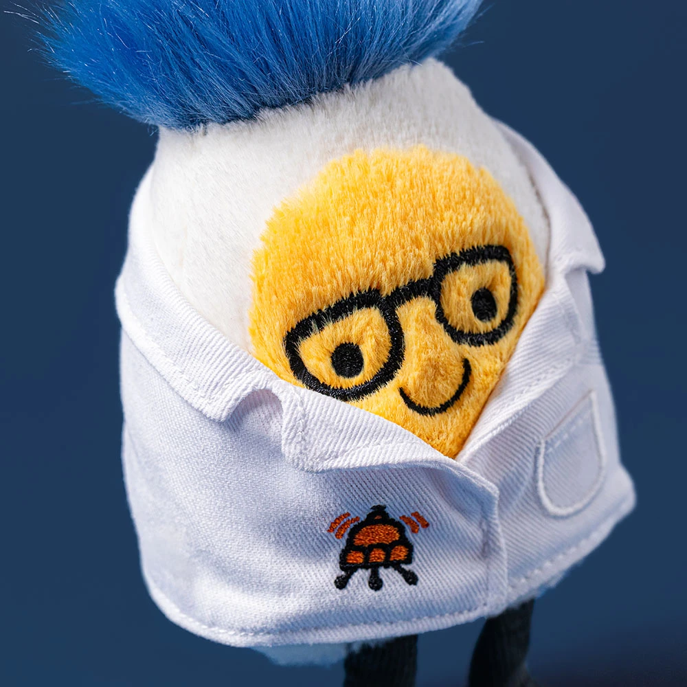 Amuseables Boiled Egg Scientist plush wearing a white lab coat and glasses with blue hair.