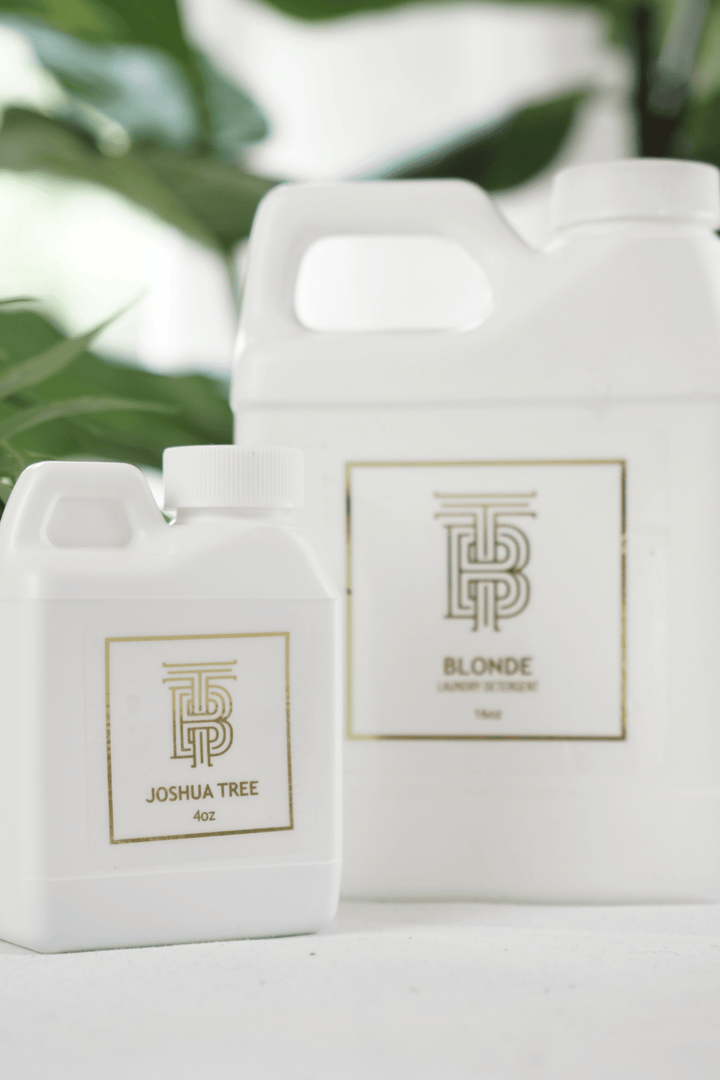 Two white bottles of Thomas Blonde laundry detergent in 4oz Joshua Tree and 16oz Blonde scents.