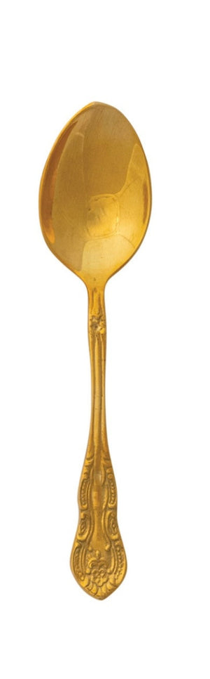 Embossed brass spoon with textured surface and curved handle
