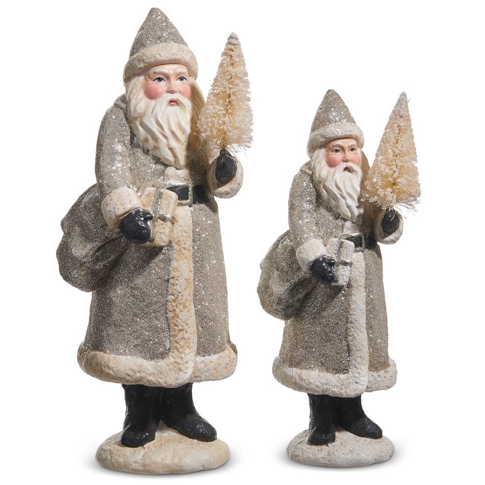 Two vintage-style Santa figurines in glittery silver coats holding small trees and gifts.