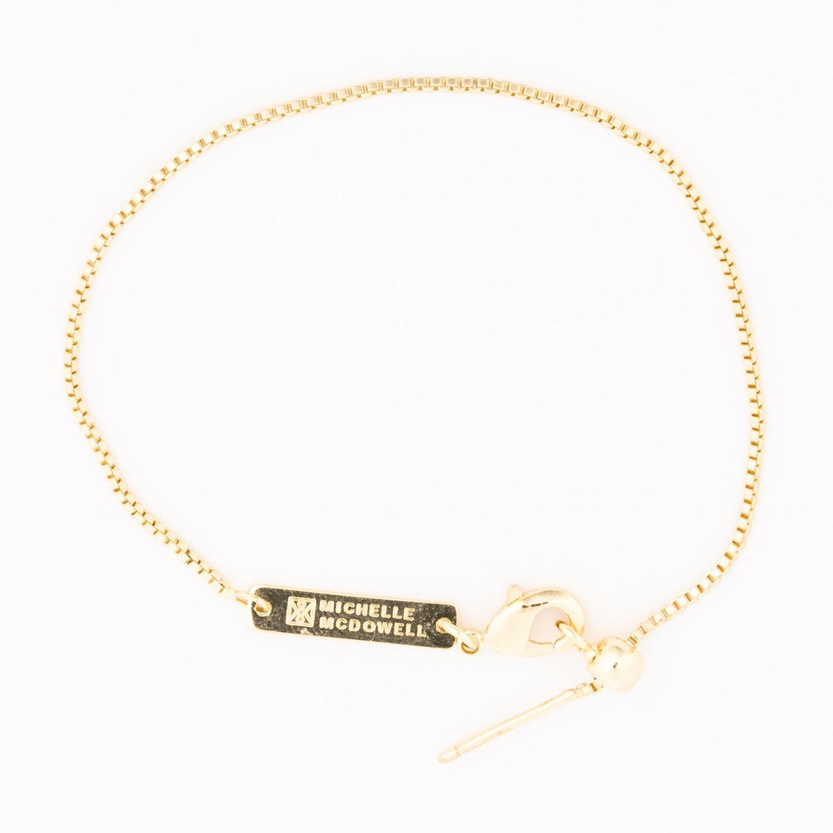 Gold-tone Sylvie bracelet featuring a delicate chain with small sparkling gemstone accents.