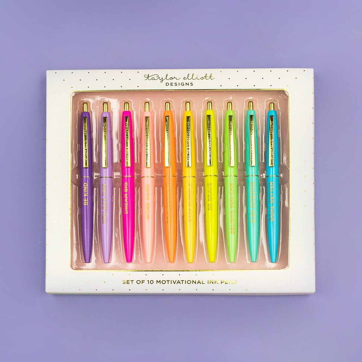 White gift box containing ten black ballpoint pens with gold foil motivational sayings.