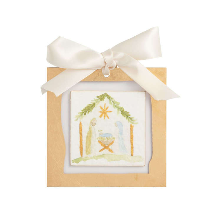 Gold painted acrylic ornament with a hand-painted nativity scene and a white satin ribbon bow.
