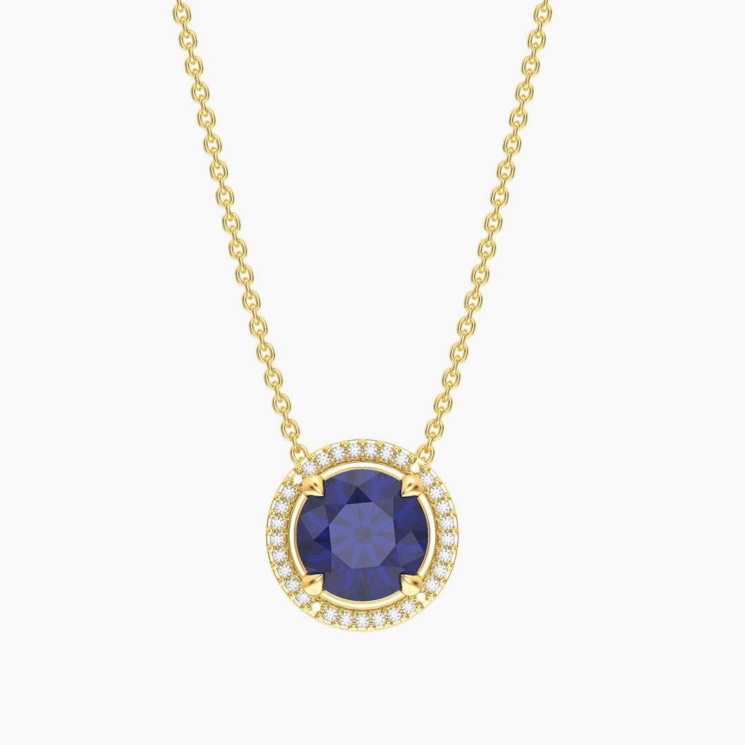 Gold-plated birthstone pendant necklace with a round blue center stone and diamond halo.
