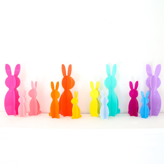 Clear acrylic bunny figurine with smooth rounded ears standing upright.