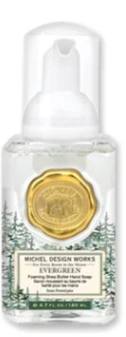 Michel Design Works Evergreen Mini Foaming Shea Butter Hand Soap with a gold seal and pine trees.