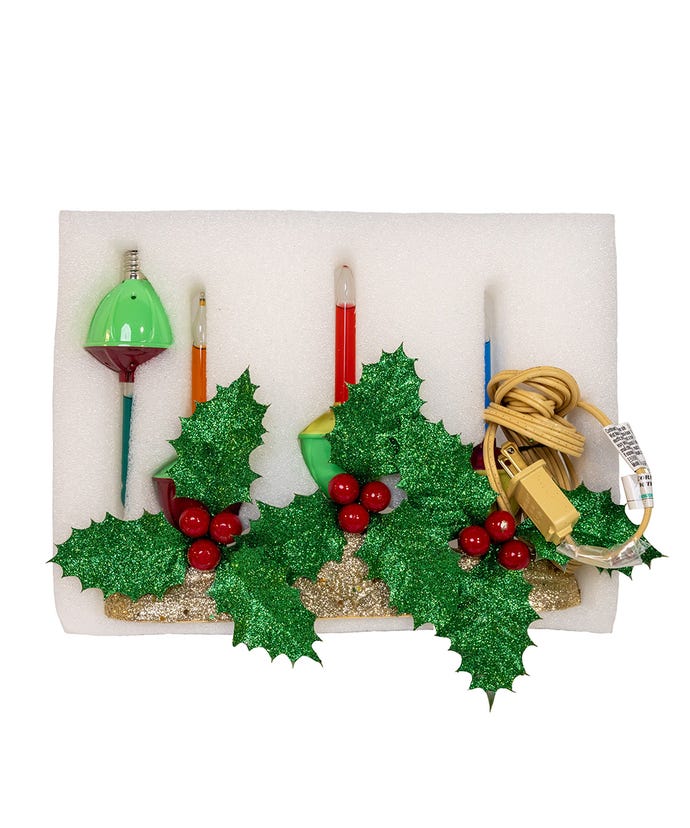 Three-bubble table piece with holly berry greenery on a gold base featuring copper accents and plastic construction.