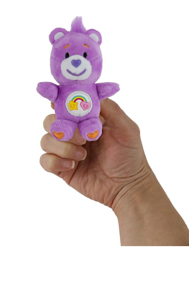 Small plush Care Bear Best Friend with a heart symbol on its chest.