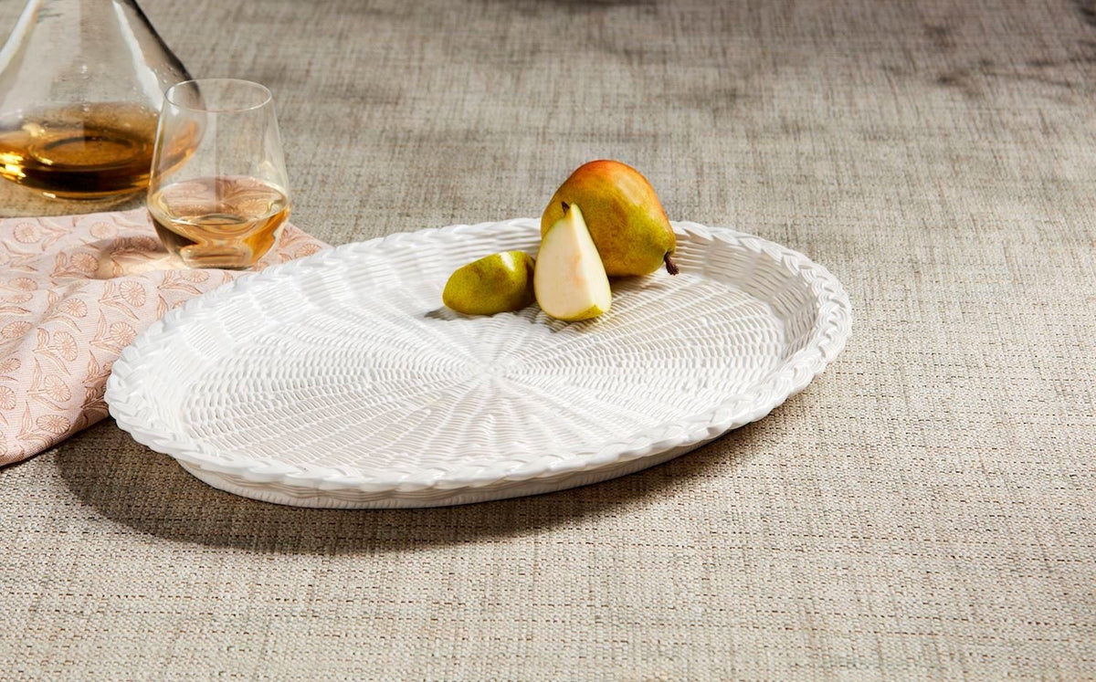 Round stoneware platter with basket weave texture in neutral tone