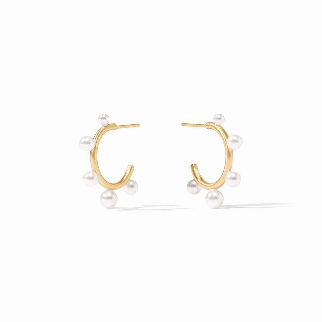 Slender golden hoop earrings with small shell pearls and gumdrop-like gemstones.