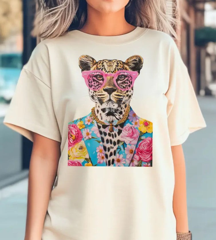 Woman wearing a natural cotton t-shirt with a cheetah in a floral jacket and pink glasses graphic.