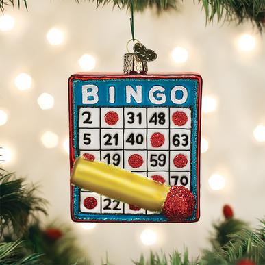 Glass Bingo card Christmas ornament with a gold dauber and red glitter markers.