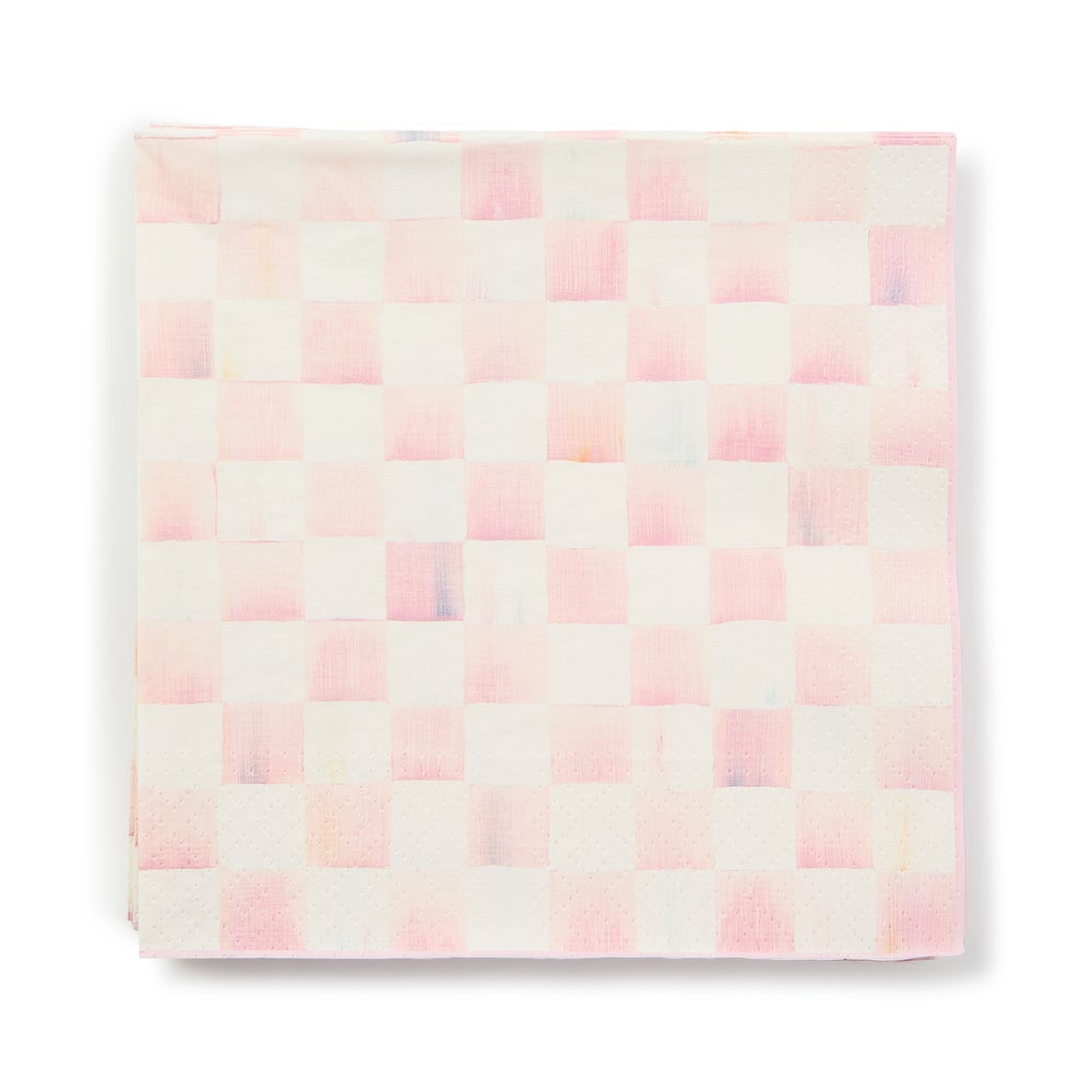 A stack of square paper napkins featuring a hand-painted pink and white checkered pattern.