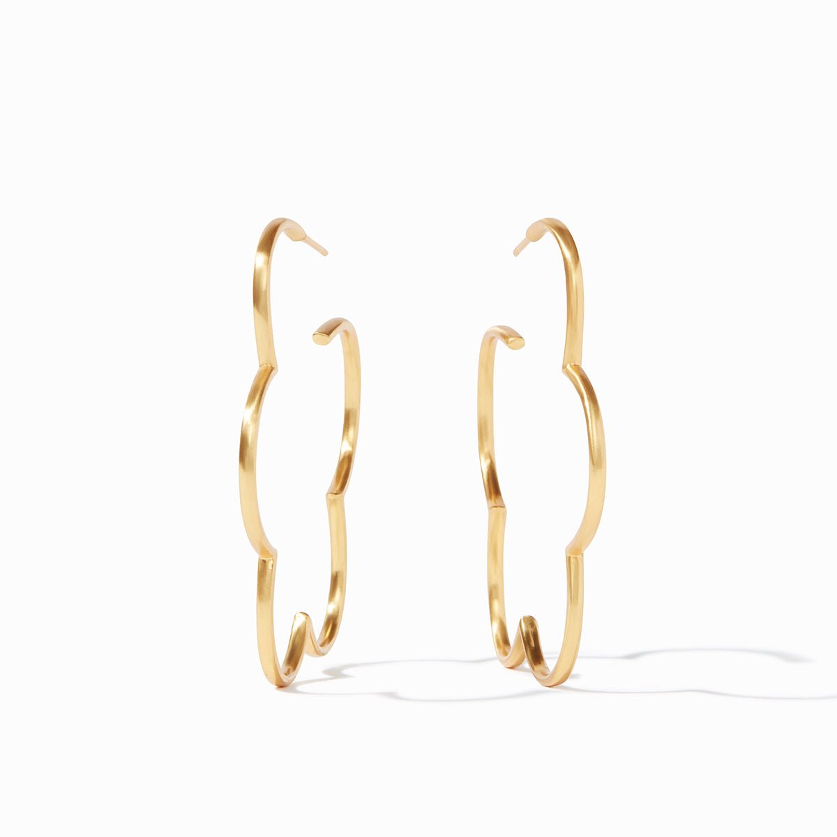 A pair of slender 24K gold-plated hoop earrings featuring a scalloped floral silhouette.