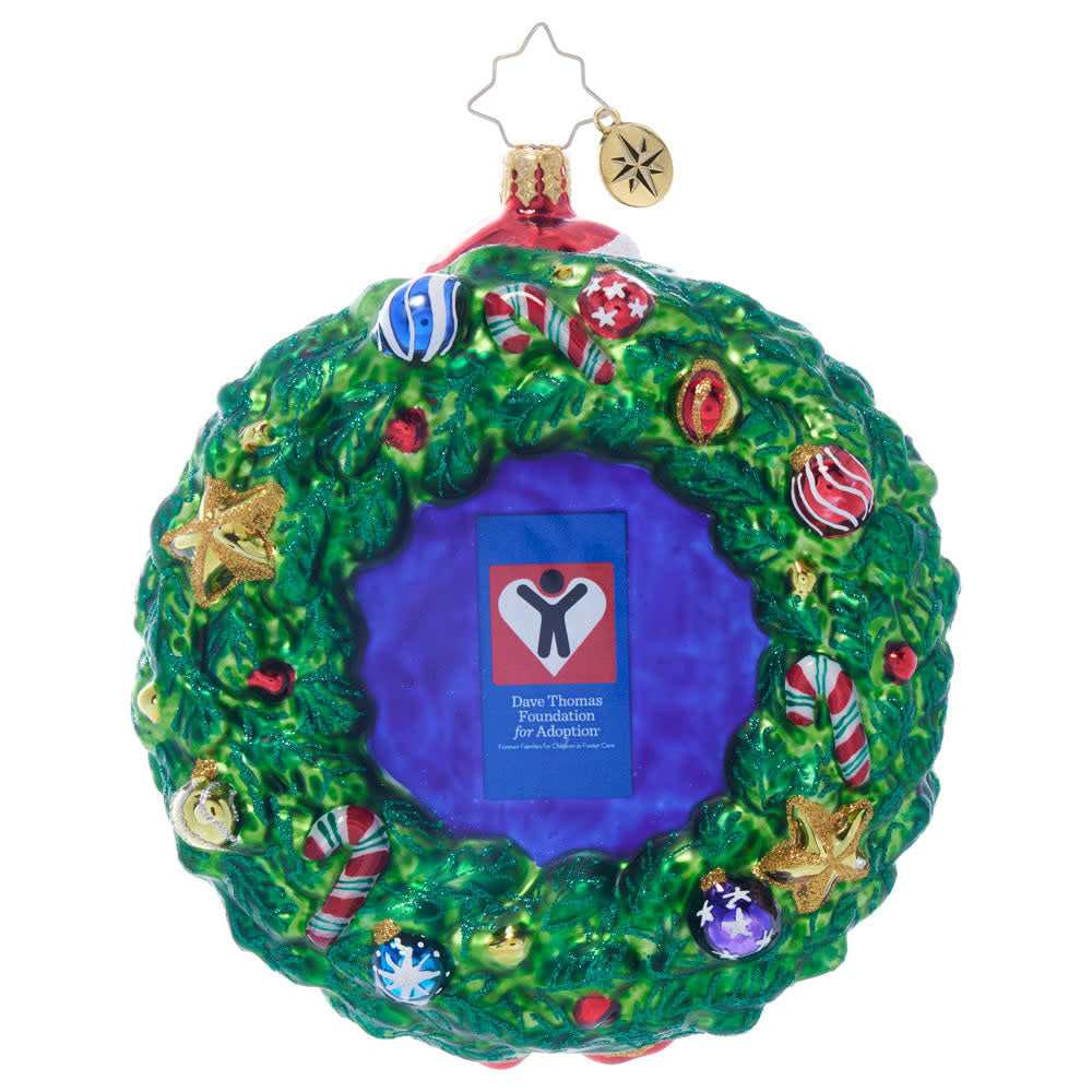 Dave Thomas Adoption Foundation wreath ornament with red berries, green leaves, and a heart-shaped cutout.