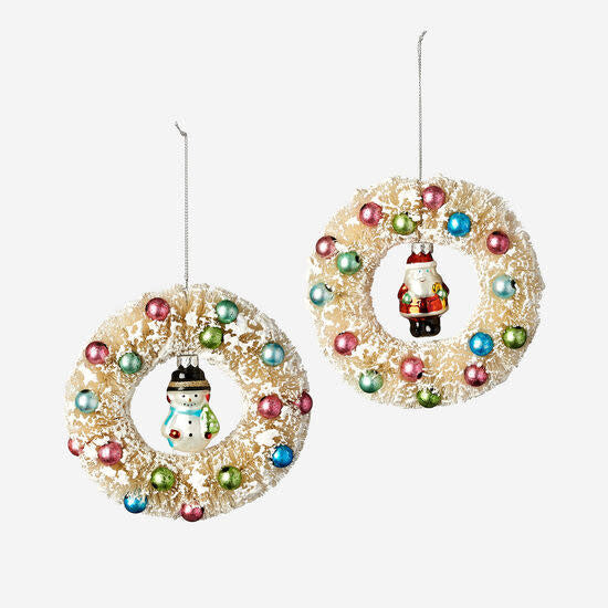 Glass wreath ornament with a round silhouette in clear material.