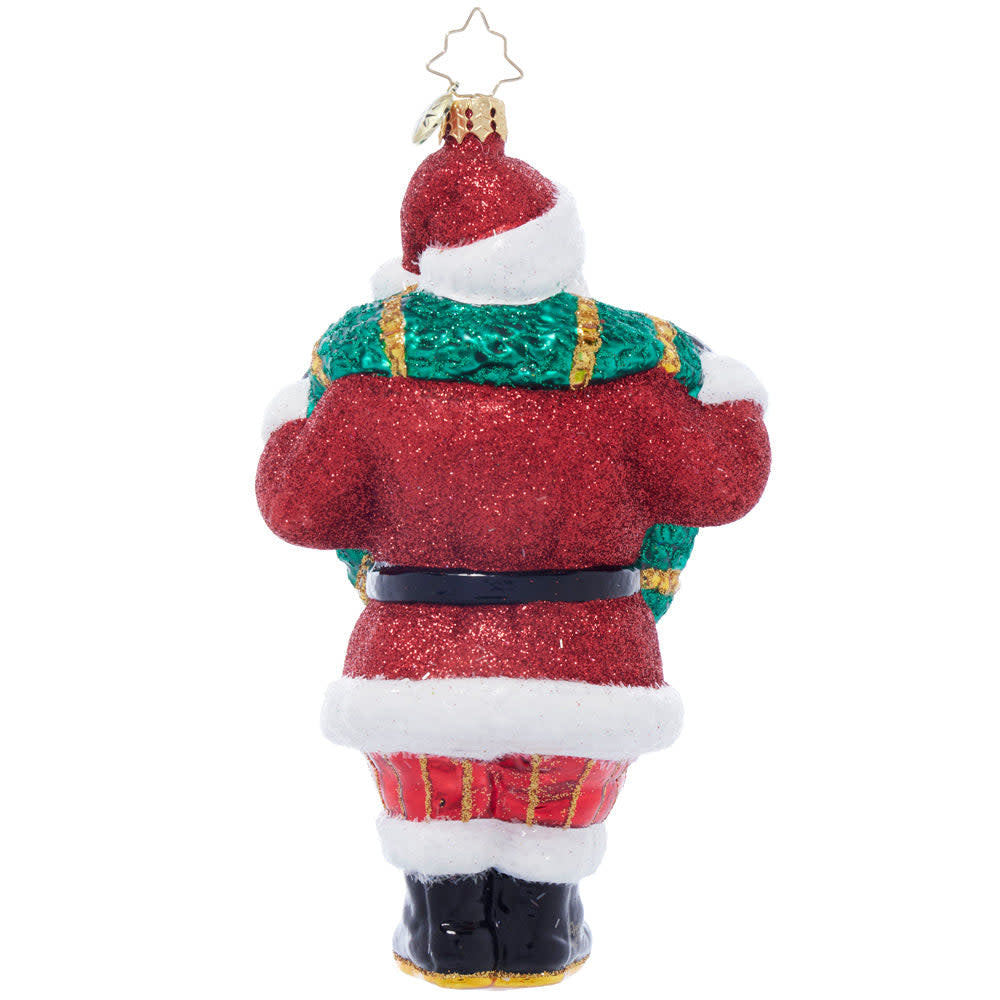 Black ceramic Santa figurine in a cowboy hat holding green holly wreaths.