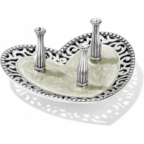 Silver enamel crystal ring holder with a daisy motif featuring three rings.