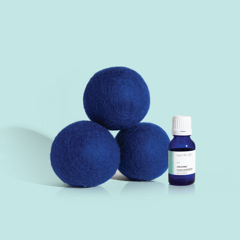 Volcano Dryer Ball Kit with three blue wool dryer balls and a small bottle of fragrance oil.