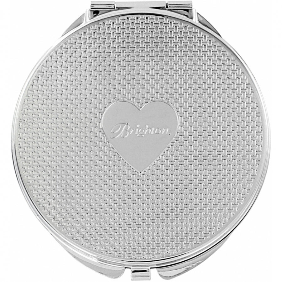 Silver plated compact mirror with pressure retractable closure and one side offering 2.5x magnification.