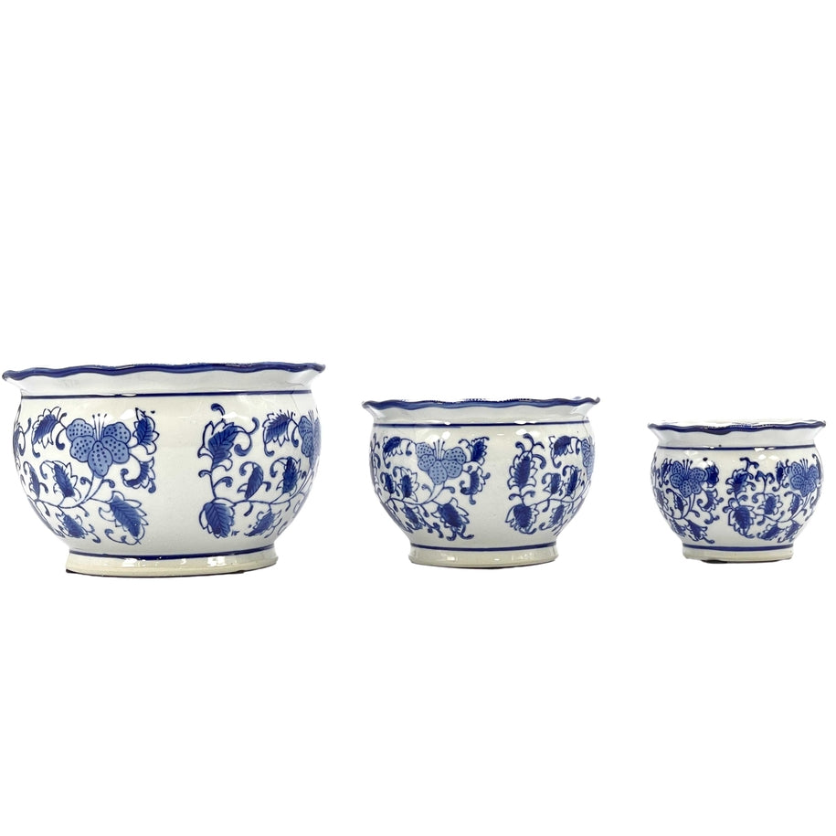 Set of three blue and white floral ceramic pots with ruffled lips in varying sizes.