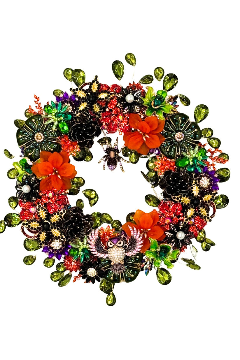 Jeweled Halloween wreath featuring orange flowers, green gems, a spider, and a central owl motif.