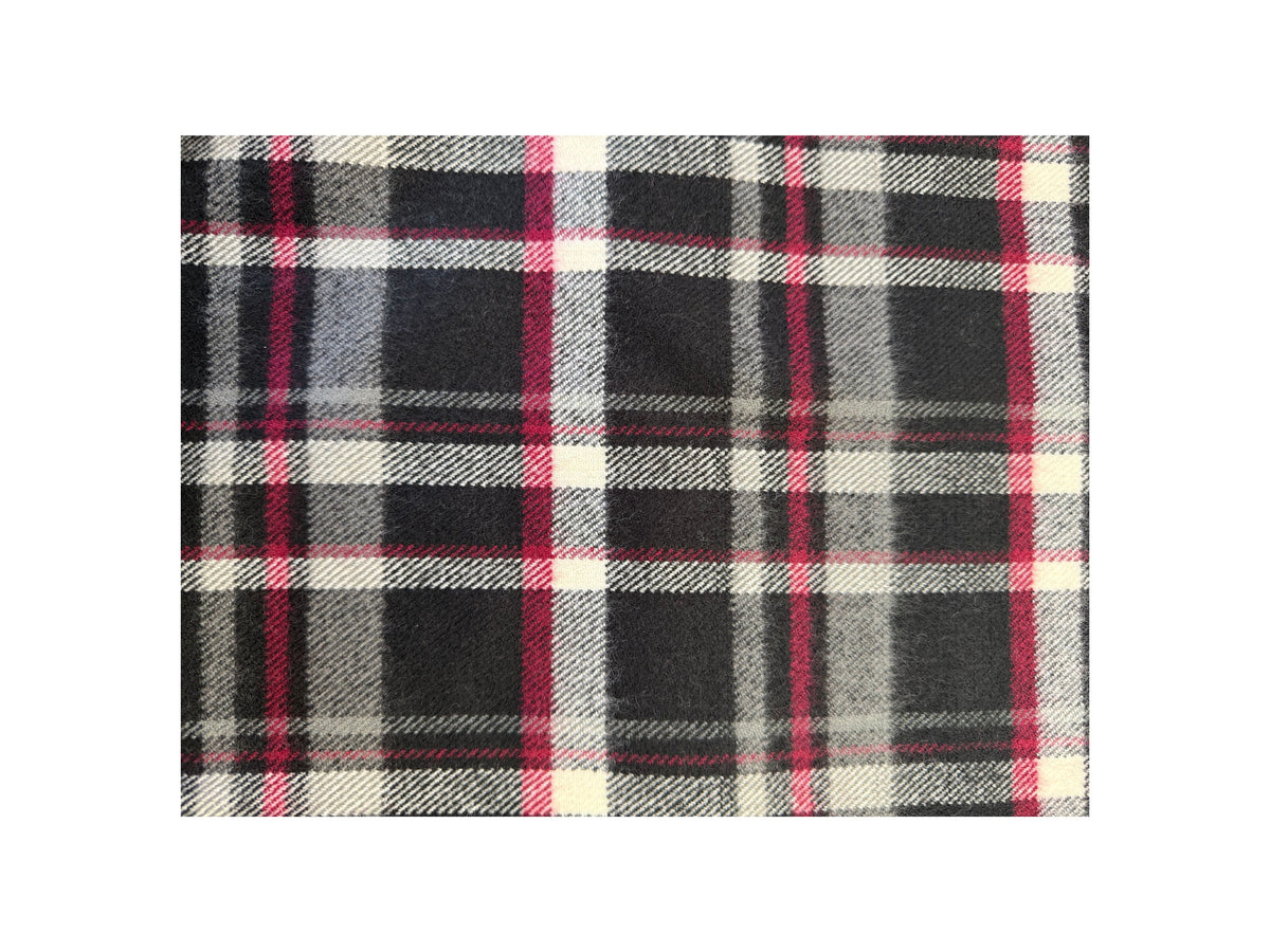 Close-up of a Scottish plaid cashmere scarf in black, grey, white, and red.