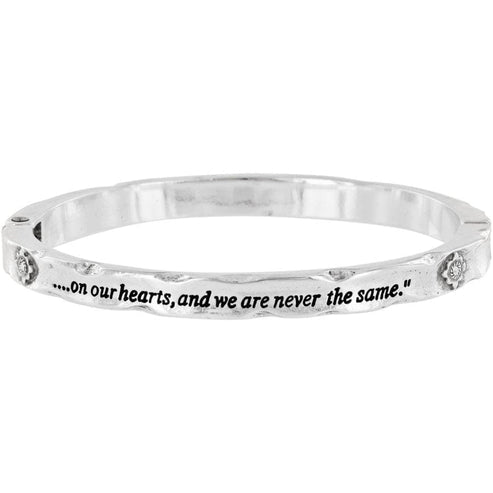 Silver plated magnetic hinged bangle featuring Swarovski crystal footprints pattern