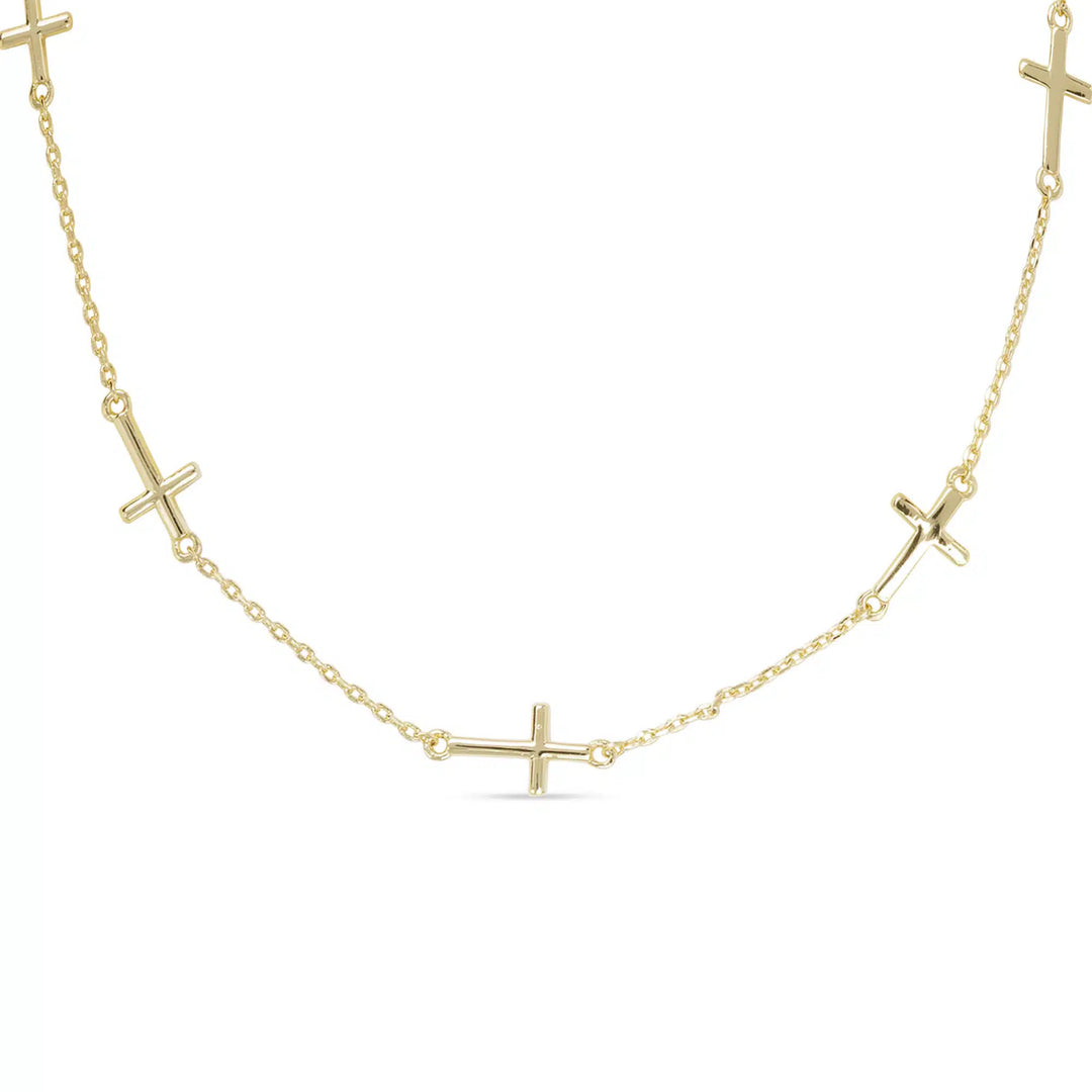 Gold station necklace with small polished cross charms spaced along a delicate chain.