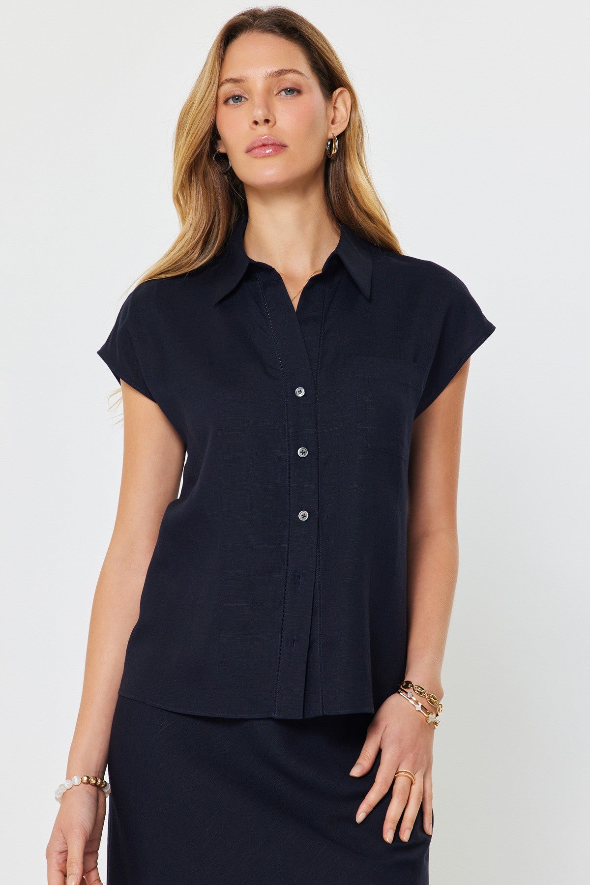 Madison cap-sleeve button-down blouse in a light neutral linen-rayon blend with a relaxed silhouette.