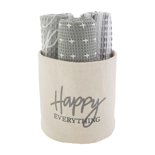 Gray and white cotton towels with patterns rolled in a canvas bucket labeled Happy Everything