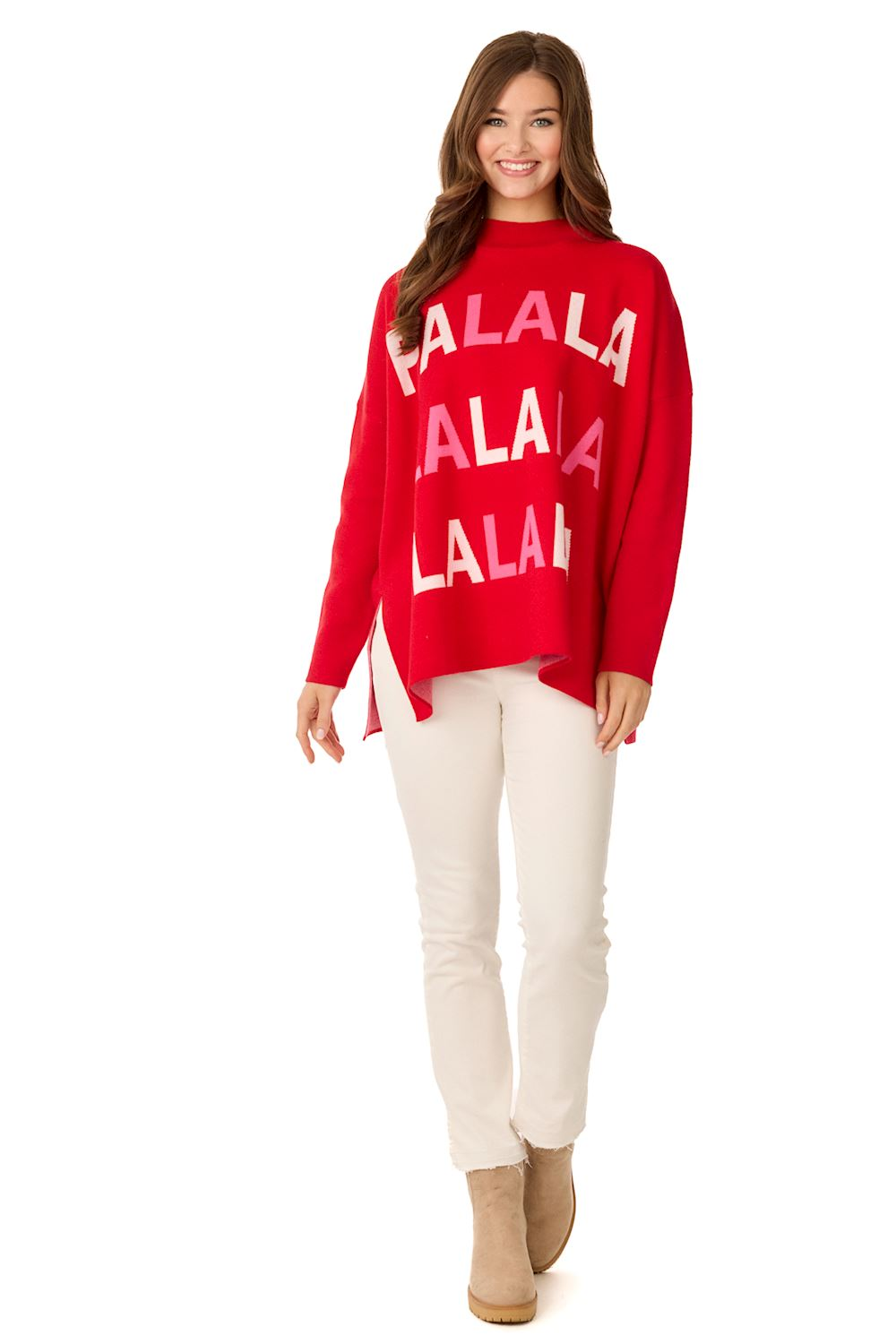 Woman wearing a red Holiday Jacquard Sweater with pink and white 'FALALA' text and white pants.