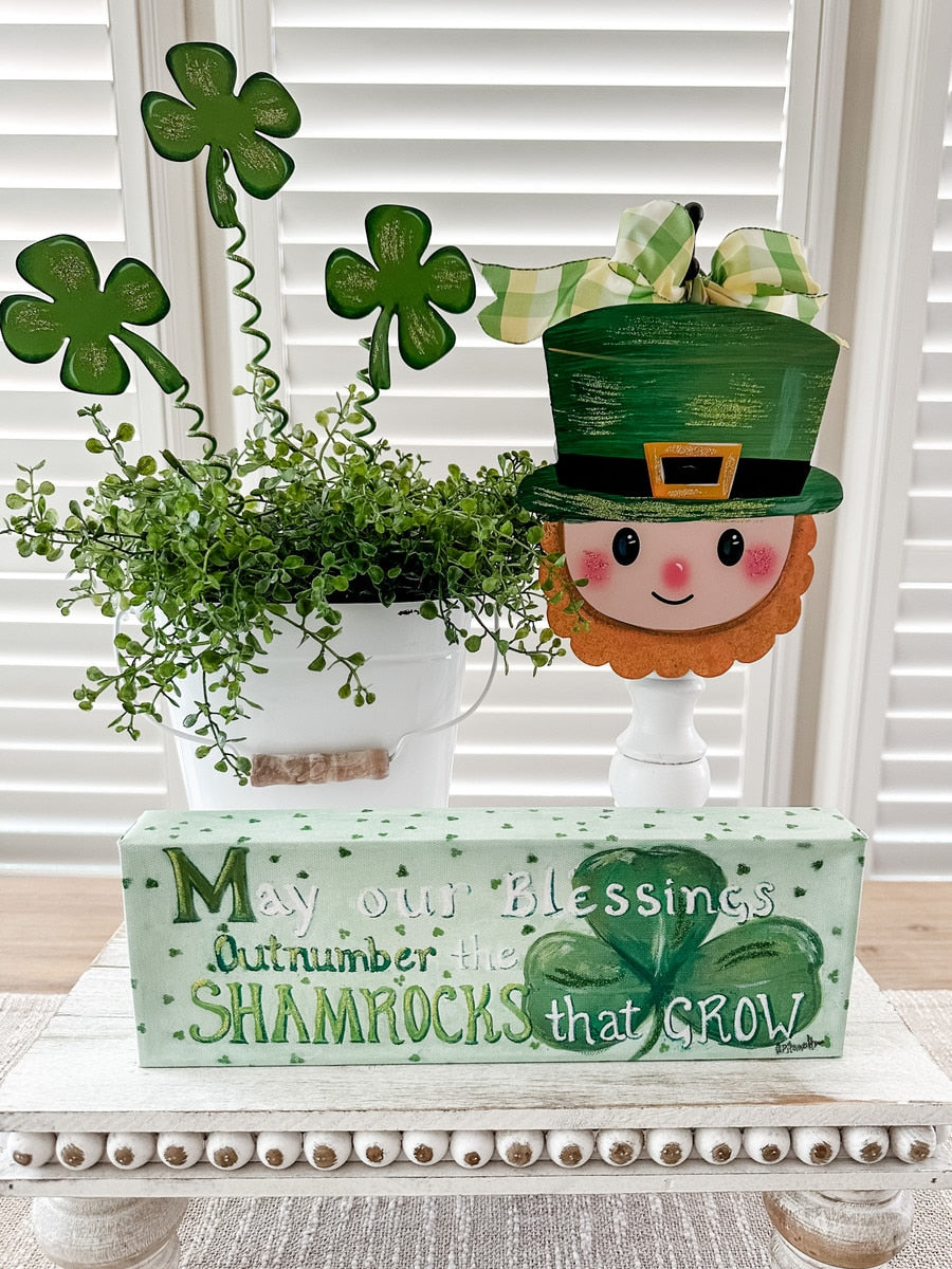 Green shamrock-patterned plastic stake measuring 8 inches wide by 14.75 inches tall.