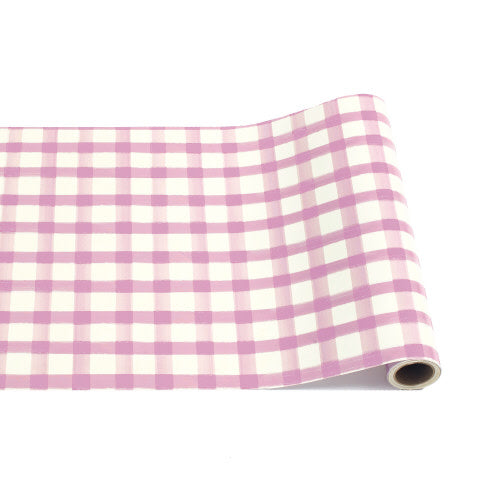 A roll of white paper table runner featuring a pink painted check pattern.
