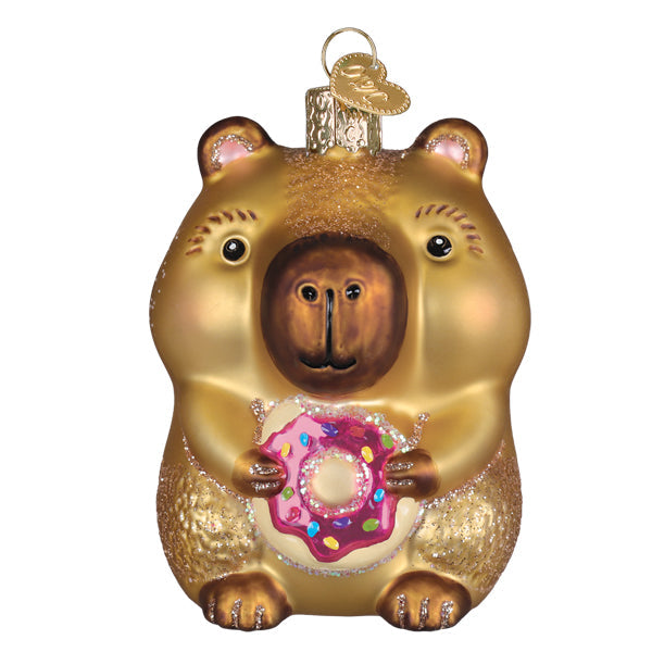Capybara eating donut ornament in pastel pink ceramic with glossy finish.